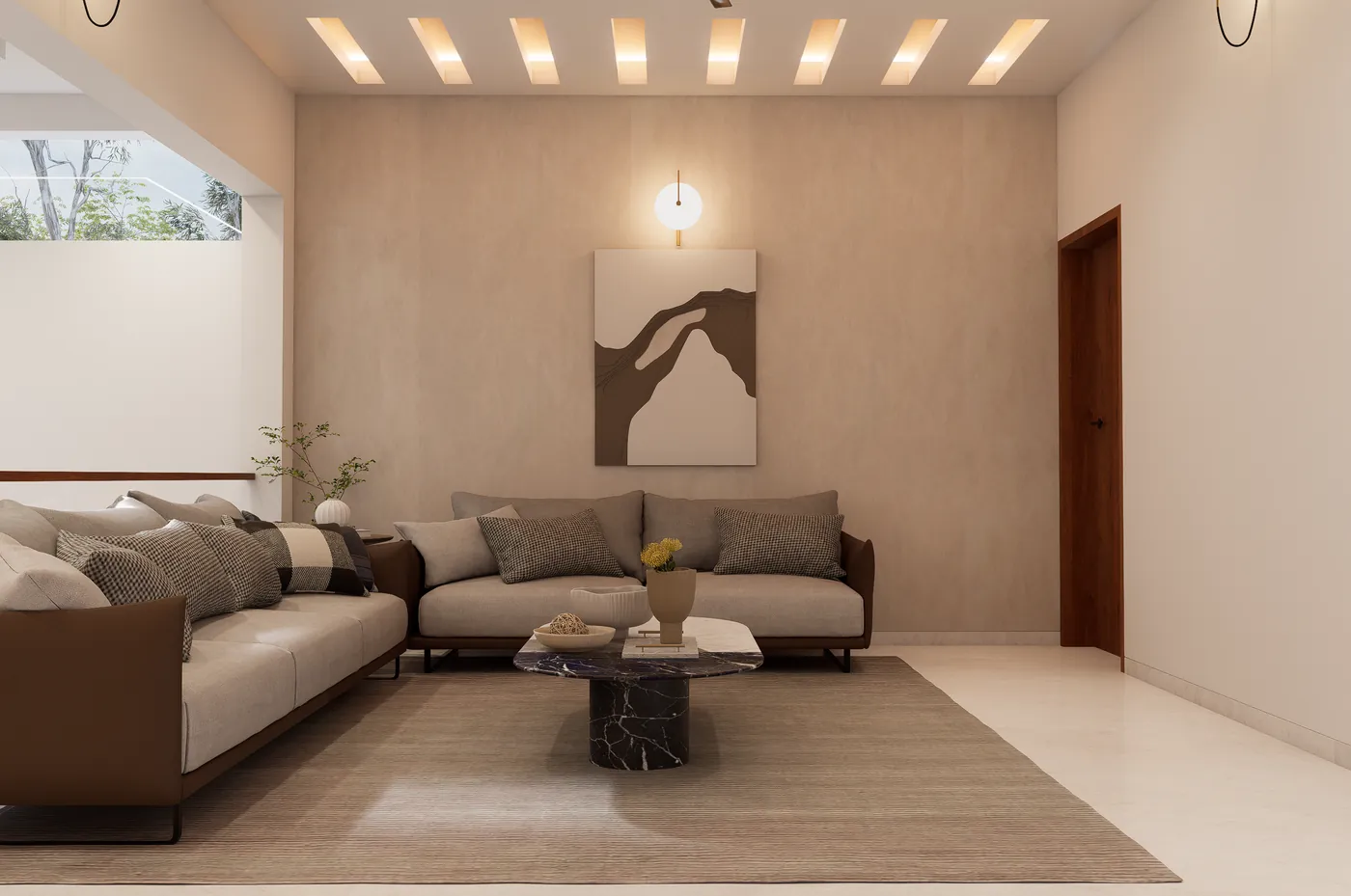 Upper-floor lounge with grey sofas and a sculptural art wall